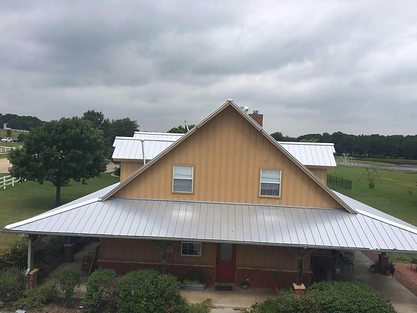 A board-and-batten home with a new metal roof
