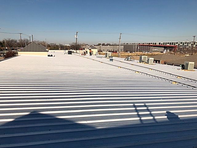 A commercial metal roof running the length of the building