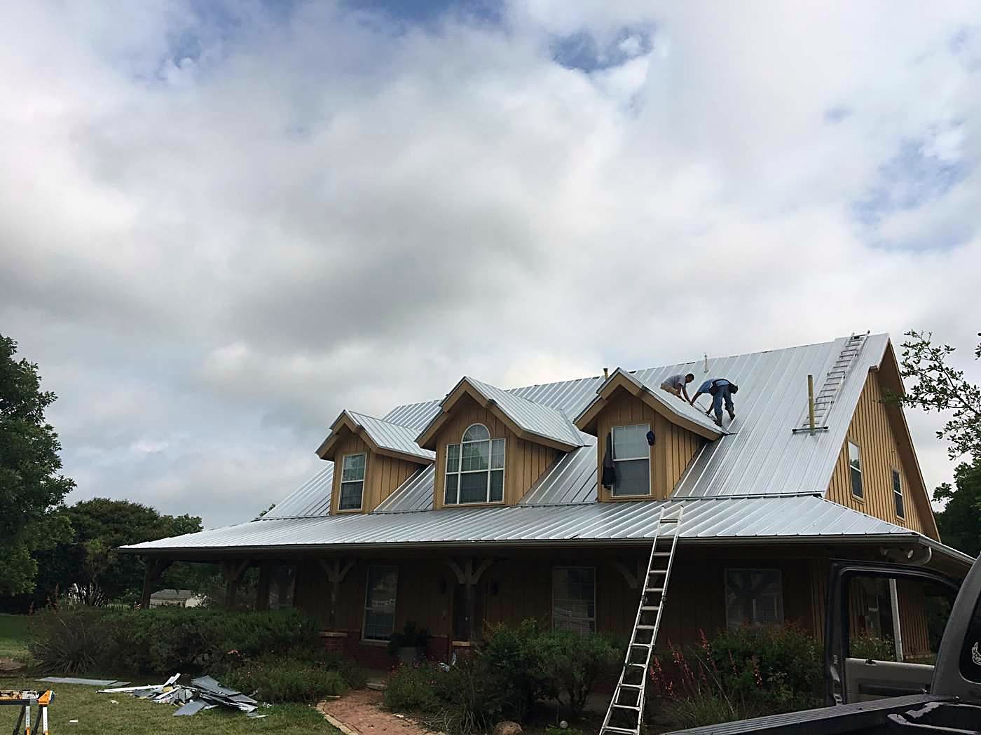 A metal roof going on a craftsman-style home