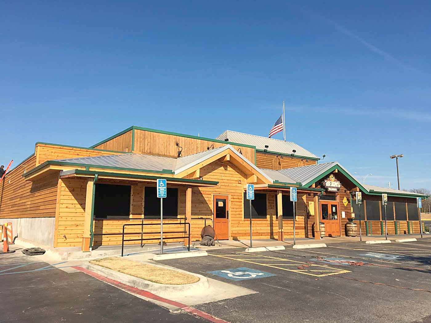 A timber-fronted commercial building under a new standing seam metal roof