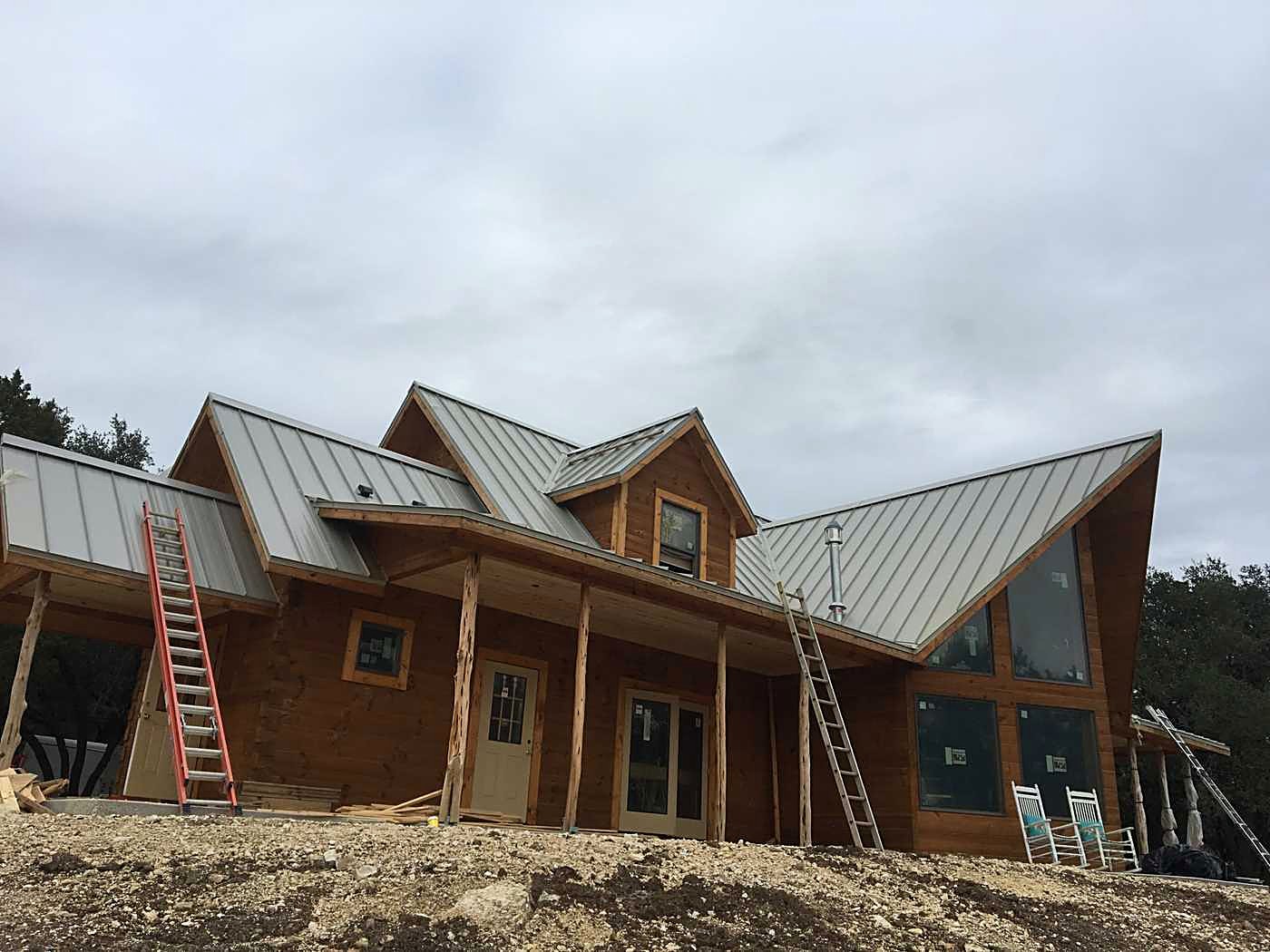 Ladders against a timber building during a metal roof install